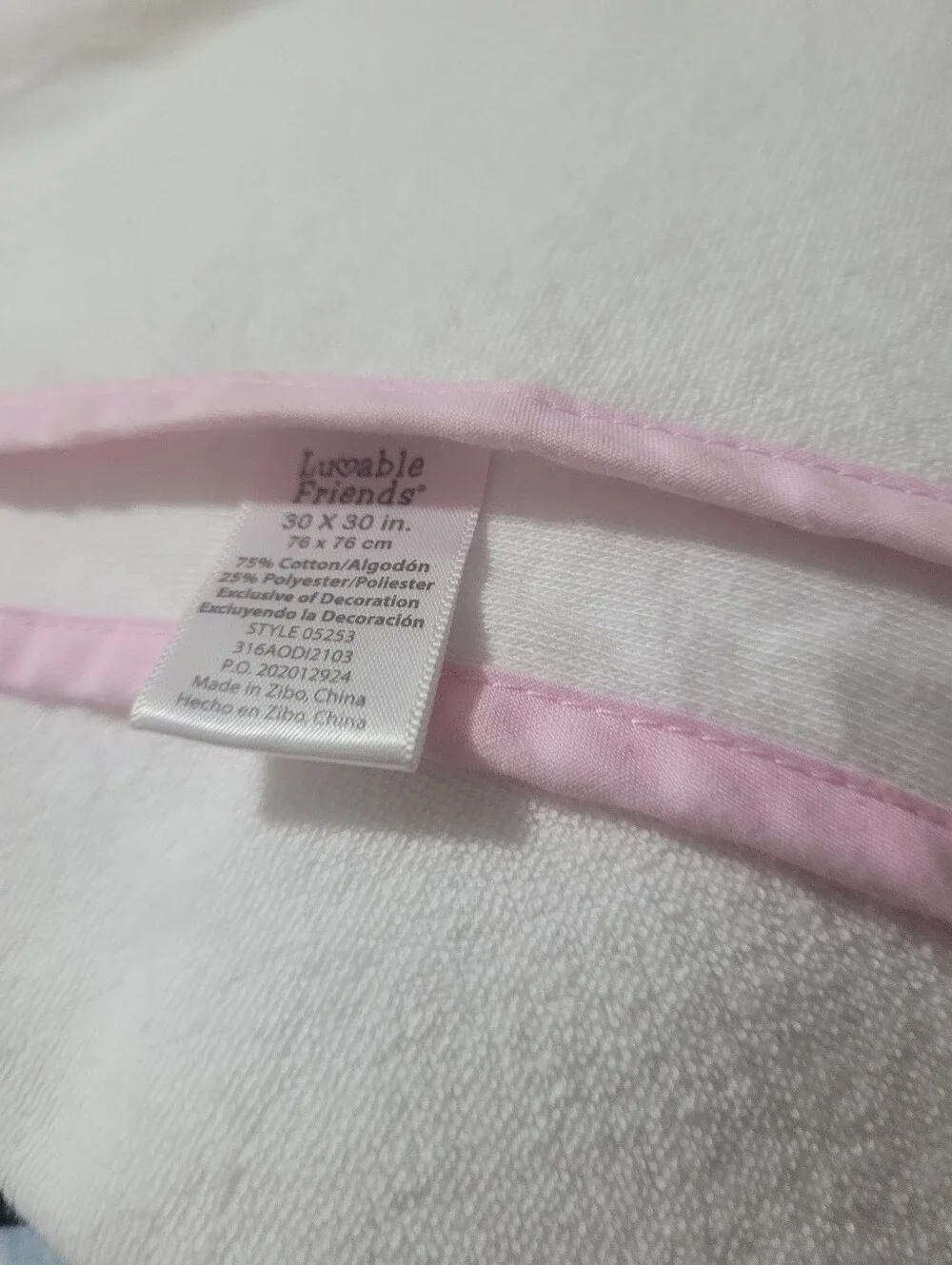 Luvable Friends'; appears to be a baby/toddler blanket or cloth with pink bindin